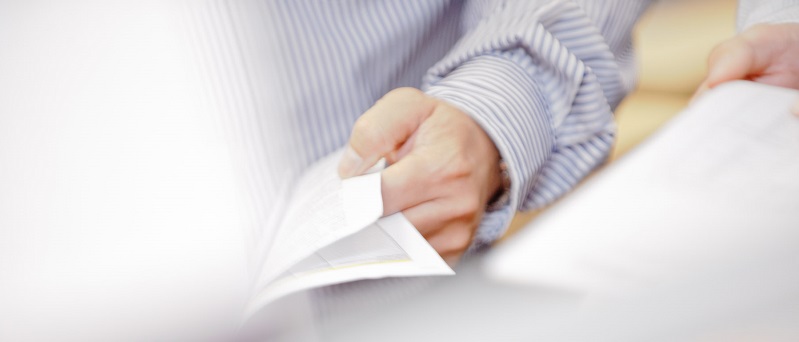 Hand on document Hand on document