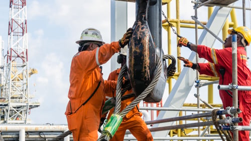 Offshore construction crews preparing the crane block for a heavy lifting